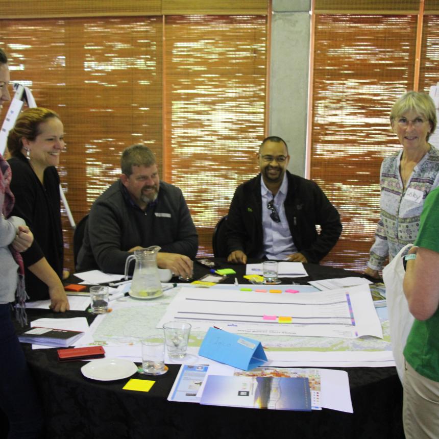 People discussing with charts on top of their tables