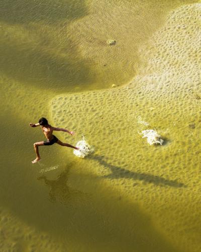 Image of a person running in a river