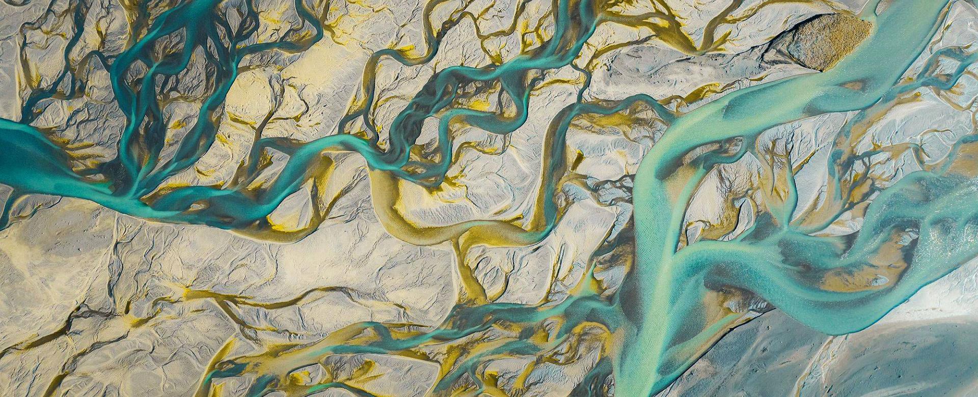 aerial view of light blue river branches