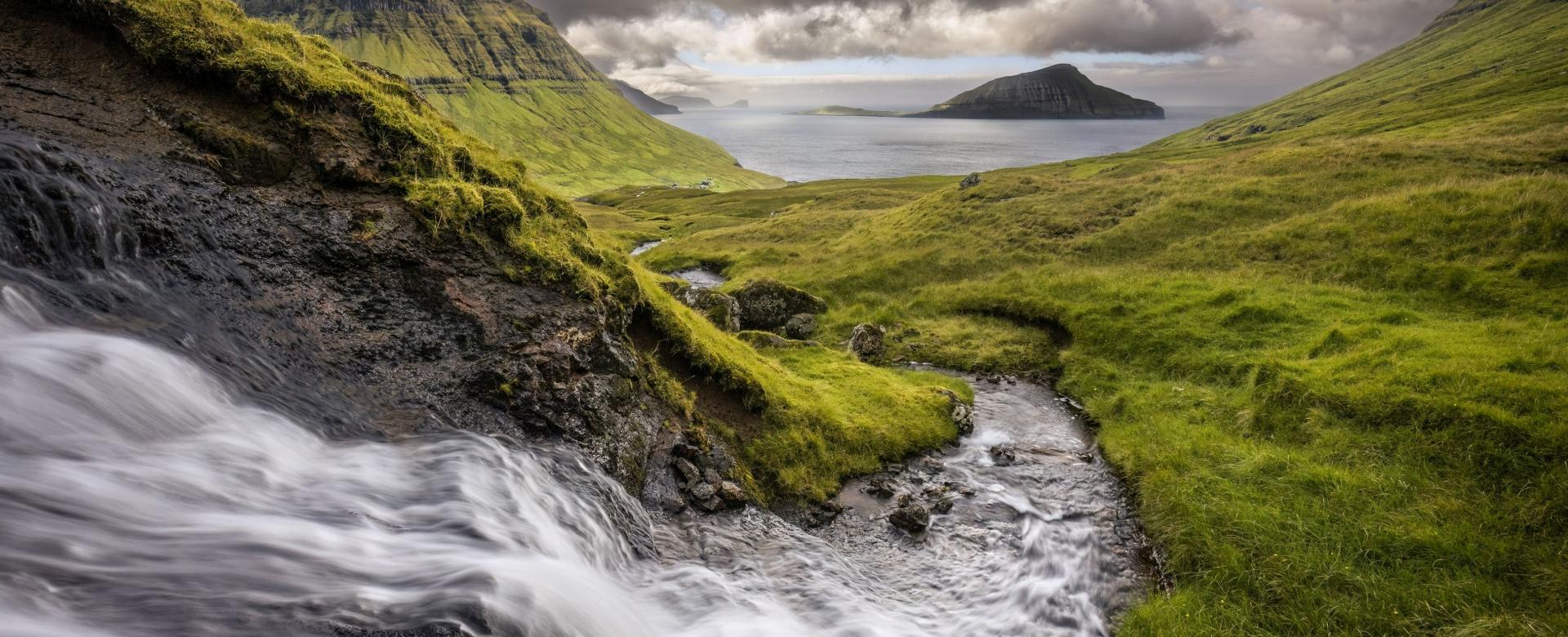 To The Ocean // During heavy rain fall in the Faroe Islands, small creeks swell, making photographing them a lot of fun, specially when the ocean serves as background.